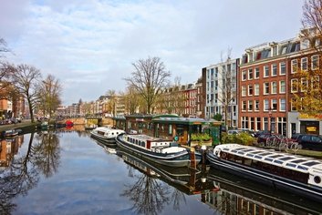 Amsterdam canal view with boats and buildings