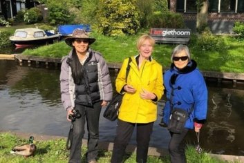 a group of women standing by a body of water