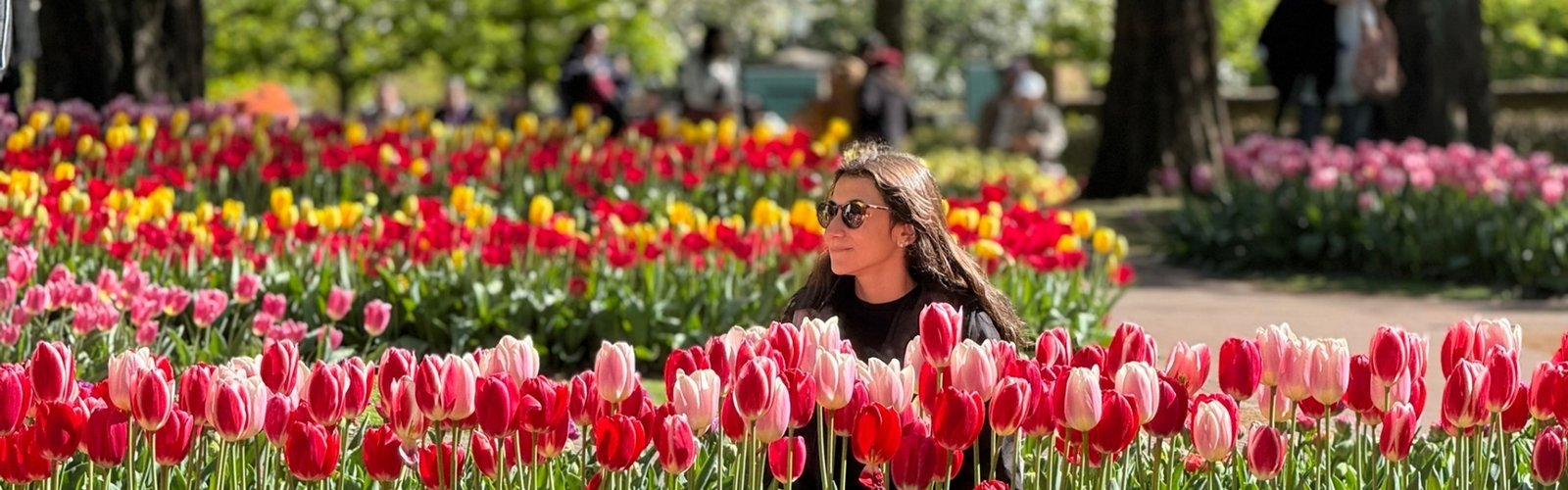 A woman poses amid a sea of flowers in Keukenhof Garden.