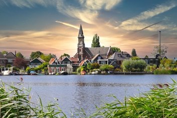 Scenic riverside village with church and greenery of Volendam