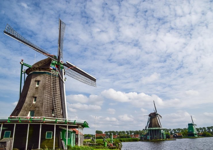 7 Easy Tips for Exploring Zaanse Schans Like a Local Zaanse Schans is one of those places that feels straight out of a Dutch storybook. With its beautifully preserved windmills, quaint green wooden houses, charming craft shops, and stunning pastoral landscapes, this historic village offers visitors a vivid glimpse into the Netherlands' rich cultural heritage. It’s a place where time seems to slow down, and every corner tells a story. But if you're truly interested in exploring Zaanse Schans in a meaningful and memorable way, it's worth taking a different approach — one that leans into authenticity. Instead of sticking to the usual tourist path, try discovering the area like a local. Not only will you find hidden gems and enjoy a more peaceful experience, but you’ll also walk away with deeper stories, unforgettable moments, and a real sense of connection to Dutch culture. Ready to elevate your journey? Here are seven easy tips for exploring Zaanse Schans like a local — from when to go and where to wander, to how to engage with the village's traditional way of life. 1. Discover the Best Time to Visit for an Authentic Experience Visit During Off-Peak Hours Timing can completely transform your experience. Many travelers miss out on the charm of exploring Zaanse Schans because they visit during the busiest hours of the day. To capture the essence of this quaint village, plan to arrive early in the morning — ideally right when it opens — or later in the afternoon, as the crowds begin to thin. The peaceful early hours bring with them a magical stillness. Without the hustle and bustle, you’ll be able to fully absorb the village’s ambiance, hear the birds chirping above the water, and take photos of iconic windmills without tourists in every shot. As the sun rises or sets over the Zaan River, the lighting becomes softer and more golden — a perfect backdrop for slow, thoughtful wandering. Choose Weekdays Over Weekends Weekends can get very busy, especially during the spring and summer months. If possible, visit on a weekday to enjoy fewer crowds and a more relaxed atmosphere. Many locals and seasoned travelers prefer midweek visits for the simple reason that they can interact more meaningfully with artisans and shopkeepers, who aren’t rushed or overwhelmed. Weekday mornings are also when school groups and tour buses are least likely to be present. This allows for a quieter, more immersive experience — and you'll have more opportunities to stop and chat with locals, whether it's a woodworker offering a spontaneous demo or a baker happy to share the history of stroopwafels. Attend Local Events and Festivals Want to experience exploring Zaanse Schans at its most festive? Time your visit around one of the village’s traditional events. The Zaanse Schans Windmill Days, typically held in May, celebrate the region’s heritage with live demonstrations, music, food stalls, and storytelling sessions. Visitors can explore working windmills, taste freshly milled flour, and witness crafts like clog-making and pewter casting in action. Other seasonal festivals — such as craft fairs or Christmas markets — offer a rich opportunity to mingle with locals, discover handmade goods, and sample traditional Dutch cuisine in an inviting atmosphere. These events transform the village into a living museum and offer some of the most rewarding ways to immerse yourself in its vibrant community spirit. 2. Explore Hidden Corners of Zaanse Schans Wander Beyond the Main Attractions Yes, the iconic windmills, cheese farms, and clog factories are must-sees, but there's so much more to discover if you're willing to stray from the main path. Instead of just following the crowd, take the time to explore the narrow back paths and lesser-known lanes. These areas are often filled with tiny gardens, art studios, and quiet benches overlooking the water. Try walking south toward the outskirts of the village, where fewer tourists venture. You'll find tranquil spots where you can sit by the river, enjoy a picnic, or simply take in the view of grazing sheep and historic wooden barns. These pockets of peace offer a more personal way of exploring Zaanse Schans, far from the hustle of tour groups. Visit Smaller, Family-Run Workshops Large-scale attractions may draw the most attention, but the real heart of Zaanse Schans lies in its intimate, family-run workshops. These spaces are often quieter and more authentic. Whether it's a fourth-generation wooden shoemaker or a small-scale cheese producer still using century-old techniques, these artisans are eager to share their craft with curious visitors. You may even stumble upon studios that aren’t on the official tourist map. If you see a hand-painted sign for handmade ceramics or specialty mustard, step inside! The owners are often delighted to share their work, tell you about their family’s legacy, and maybe even offer a sample of their creations. Seek Out Authentic Local Eateries Skip the more obvious tourist cafes near the entrance and look for hidden gems tucked into the back streets or just outside the main loop. These smaller bakeries and cafes often serve up incredibly delicious, home-style Dutch treats that you won’t find in chain establishments. Try a warm gevulde koek (a spiced almond-filled cookie), fresh apple pie, or a hearty broodje kaas (cheese sandwich made with local dairy products). Dining in these spots not only supports local businesses but adds another layer of authenticity to your experience of exploring Zaanse Schans. 3. Engage with Local Craftsmen and Artisans Participate in Hands-On Workshops One of the most enjoyable ways to deepen your visit is by learning a traditional craft first-hand. Several workshops in Zaanse Schans offer hands-on experiences, from clog-carving to cheese-making, and even tile-painting in the famous Delft blue style. These interactive sessions usually last between 30 minutes to two hours and give you the chance to create a one-of-a-kind souvenir. It’s a meaningful way to connect with the region’s traditions, and a much more memorable alternative to browsing souvenir racks. Be sure to check in advance for availability — these workshops can fill up quickly, especially in high season. Booking ahead ensures you won’t miss the chance to engage with the village’s creative heritage. Purchase Authentic Souvenirs Directly from Artisans When you buy directly from artisans, your purchase supports their work and helps sustain centuries-old crafts. Whether it’s a hand-painted tile, a wooden clog carved while you watch, or a wheel of fresh cheese sealed in wax, these items carry a personal touch that mass-produced trinkets simply don’t offer. Not only are these keepsakes more special, but many artisans will tell you the story behind the object — where the wood came from, which family member inspired the design, or how the technique has been passed down. It’s these stories that make exploring Zaanse Schans deeply enriching. Learn the Stories Behind the Crafts The crafts of Zaanse Schans aren’t just about what’s made — they’re about how and why. Every artisan has a history, and most are more than happy to share it. Ask them about their training, their materials, and the significance of their craft in Dutch culture. You might learn that a certain weaving pattern was traditionally used in wedding garments or that a paint pigment is made using regional clay. These insights breathe life into the objects you take home and offer a deeper understanding of the village itself. What may seem like a simple souvenir becomes a vessel for culture, memory, and tradition. 4. Master the Art of Local Transportation Use Biking to Explore Effectively One of the best ways of exploring Zaanse Schans like a local is on two wheels. Biking is deeply ingrained in Dutch life, and the village is designed with cyclists in mind. Rent a bike from a local shop and pedal your way along scenic trails that wind through meadows, past windmills, and over small wooden bridges. There’s a dedicated cycling route called the Zaanse Schans Windmill Route, which takes you through the surrounding countryside and connects nearby villages such as Zaandijk and Wormerveer. It’s a refreshing, eco-friendly, and authentic way to see more of the region at your own pace. Take the Nelson Flight or Local Bus If you’re short on time or looking for a different perspective, consider hopping on a boat tour or a local bus. The Nelson Flight (a popular sightseeing boat) lets you explore the waterways and see Zaanse Schans from a completely different angle — all while enjoying a relaxing ride. Alternatively, take one of the regional buses from Amsterdam or Zaandam. They’re convenient, affordable, and provide a more local commuting experience than a private taxi. Walk the Village for a Closer Look Don’t underestimate the joy of walking. Strolling through Zaanse Schans allows you to notice small details — like hand-carved house signs, flower boxes bursting with tulips, and curious ducks waddling by the dikes. On foot, you can pause whenever something catches your eye and take your time exploring. Walking also opens the door to spontaneous conversations, impromptu photo ops, and quiet reflection — essential ingredients in any meaningful journey. 5. Respect Local Customs and the Environment Follow Responsible Tourism Guidelines Zaanse Schans is not just a tourist attraction — it’s a living village with real residents. Be respectful by staying on designated paths, not entering private homes or gardens, and obeying posted signs. These simple acts of consideration help maintain the harmony of the area. Dispose of your trash properly, avoid feeding animals, and stick to eco-friendly behaviors. This not only helps protect the environment but also sets a positive example for other visitors. Support Sustainable and Ethical Tourism Choose local guides, eco-certified tours, and handmade goods over imported souvenirs. Read up on the area’s ecology and history before you go, so you can better appreciate the delicate balance that makes this place so special. Supporting sustainability ensures that future generations will also have the chance to enjoy exploring Zaanse Schans in all its natural and cultural beauty. Be Courteous and Engage Respectfully A smile and a friendly "Hallo!" go a long way. Ask permission before taking someone’s photo, and take a moment to thank artisans and shopkeepers who’ve shared their time or craft with you. Building these human connections makes travel more meaningful. Locals are far more likely to open up when treated with respect and curiosity. 6. Maximize Your Visit with Local Tips and Resources Use Official Tour Guides and Maps Pick up a printed guide at the entrance or download an app from the Zaanse Schans official website. These resources often highlight under-the-radar spots, special exhibits, and seasonal events. They’ll help you create your own itinerary while also allowing room for spontaneity. Some guides even include audio tours narrated by locals, providing fascinating context as you explore each area. Consult Local Tourism Offices The staff at local information centers are invaluable sources of knowledge. Ask them for recommendations on new shops, upcoming workshops, or peaceful walking trails. They often know which attractions are temporarily closed, which ones are newly opened, and where you can find a quiet place to watch the sunset. Read Blogs and Forums for Up-to-Date Insights Travel blogs and forums like TripAdvisor or Reddit can give you the most current, firsthand insights into what to expect during your visit. Bloggers who specialize in the Netherlands or cultural tourism often post updates about hidden gems, new attractions, or personal itineraries that can inspire your own. By combining local insight with real-time traveler experiences, you can shape your journey in a way that’s both informed and uniquely yours. Conclusion: Your Journey to the Heart of Dutch Heritage In the end, exploring Zaanse Schans like a local isn’t just about avoiding crowds or seeing different sights — it’s about changing your perspective. By choosing slower, more thoughtful travel, you open yourself up to genuine experiences, rich cultural interactions, and moments of quiet beauty. Whether you’re biking past windmills, chatting with a shoemaker, or savoring a homemade stroopwafel from a hidden café, every step you take through Zaanse Schans becomes part of a story — your story. One that’s built not just on what you saw, but how you experienced it. So skip the rush, embrace the pace, and let Zaanse Schans reveal its magic, one quiet discovery at a time.